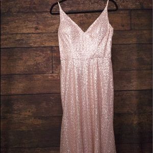 A long pink dress covered in pink and gold sequins